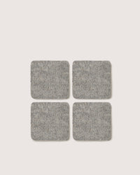 Four graf lantz square gray felt pads crafted from German Merino wool are positioned in a 2x2 grid on a simple white background.