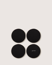 A grid of four black coasters, made from German Merino wool, is set against a light background. The text graf lantz is visible on the bottom right coaster.