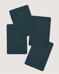 Four dark blue, blank Graf Lantz playing cards overlap and fan out against a plain white background.