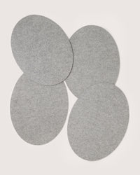 Four overlapping gray felt ovals from graf lantz form an elegant, designer-inspired look with a casual, asymmetrical pattern on a light background.