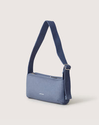 A Graf Lantz blue rectangular Campus Shoulder Bag with an adjustable strap is shown against a plain background. It has a minimalist design with a small white text logo on the front and a top zippered opening.