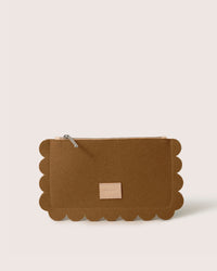 The Graf Lantz Deco Edge Pouch features scalloped edges, a zipper, and a small beige label on the front. Set against a plain white background, this versatile brown clutch adds elegance to any ensemble while securely storing essentials.