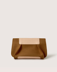 The Graf Lantz brown clutch purse, sustainably crafted from Merino wool with light beige leather accents, rests elegantly on a plain white background.