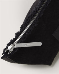 Close-up of black textured fabric featuring a partially open silver zipper on the left, showcasing artisanal craftsmanship akin to a Hana Pouch. The zipper pull is engraved with Graf Lantz.