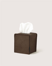 A brown, square Graf Lantz tissue box holder with a white tissue protruding from the top, set against a plain light background.