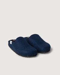 A pair of graf lantz dark blue slip-on clogs with a fabric texture and flat black recycled rubber sole is placed side by side on a plain, light-colored background.
