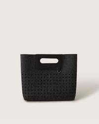 A graf lantz dark gray Merino Wool rectangular tote bag features a cutout handle and small circular perforations on the lower half. Set against a light neutral background, it highlights the minimalist design.