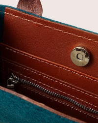 Interior of Jaunt Merino Wool Mini Tote in Moss and Kombu with brown leather accents and cnap button and zipper
