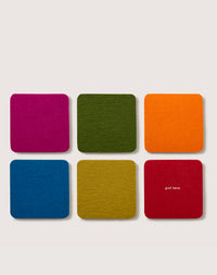 Six colorful Merino wool coasters from graf lantz are arranged on a light surface. The top row features magenta, green, and orange; the bottom shows blue, yellow, and lime green. Made from sustainable materials, one coaster is embossed with graf lantz.