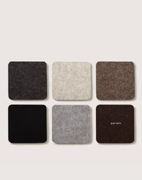 Six gray and brown square coasters made from sustainable German Merino wool are set in two rows on a light background. The coaster at the bottom right corner subtly displays graf lantz.