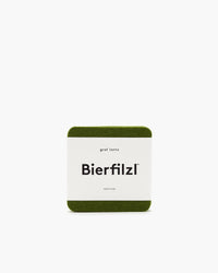 The Graf Lantz Bierfilzl is a square, green felt coaster with rounded edges, crafted from German Merino wool. This minimalist design includes Made in USA beneath the main text.