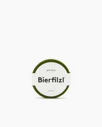 A set of round, green coasters from German Merino wool features a white paper band with Bierfilzl and graf lantz text, elegantly displayed against a plain white background.