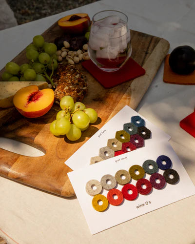 Wine markers are a must-have wine accessories shown alongside a fruit board