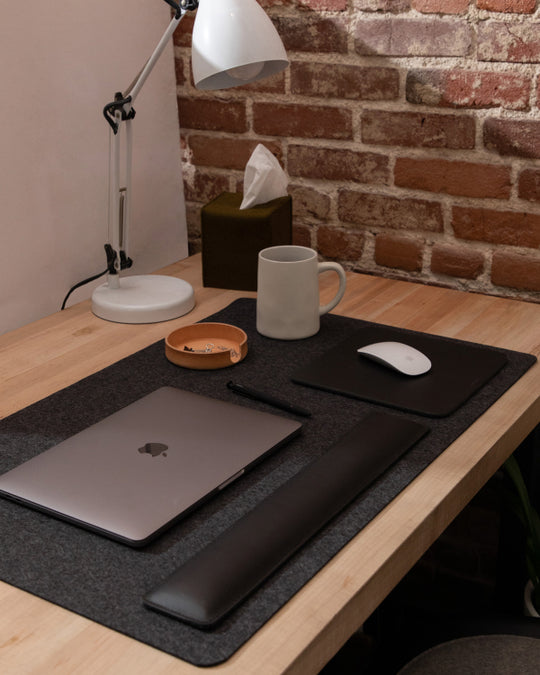Office setup with black desk pad