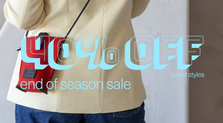 Person wearing a cream jacket and blue jeans with a red crossbody bag. Large yellow text overlays the image, reading 30% OFF select styles.