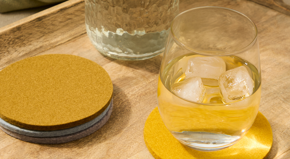 Glass of water resting on a Graf Lantz Merino wool coaster