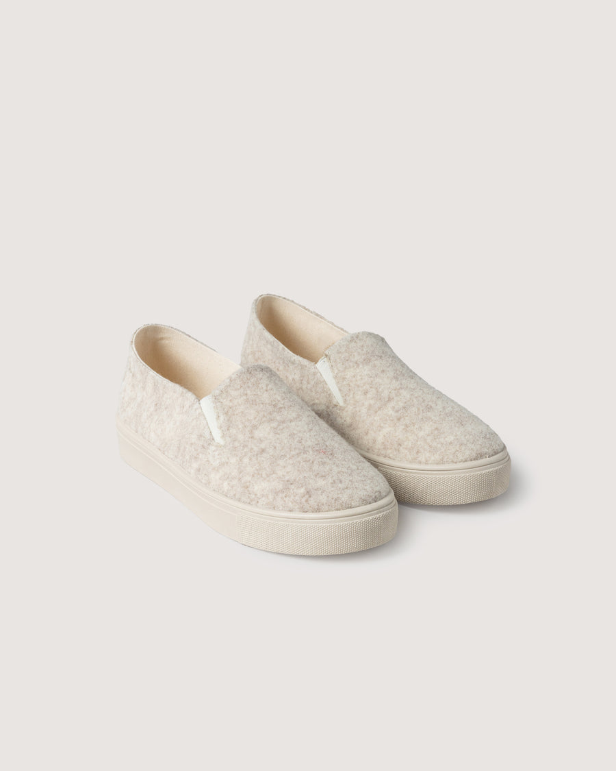 Our wool is breathable and durable, the soles are made from recycled rubber and the cotton canvas lining provides all-day comfort:  Haus Merino Wool Felt Slip-on. Here in heather cream color.
