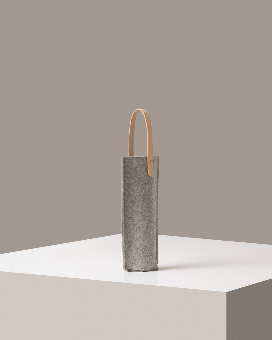 A light grey Hana Merino Wool Bottle Bag on a white base displayed in a side-view
