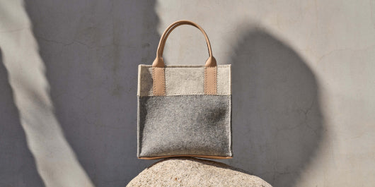 White and gray Jaunt Merino Wool Mini Tote bag by Graf Lantz sitting on a gray rock