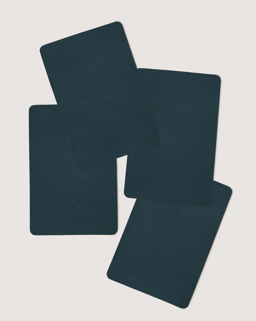 Four dark blue, blank Graf Lantz playing cards overlap and fan out against a plain white background.