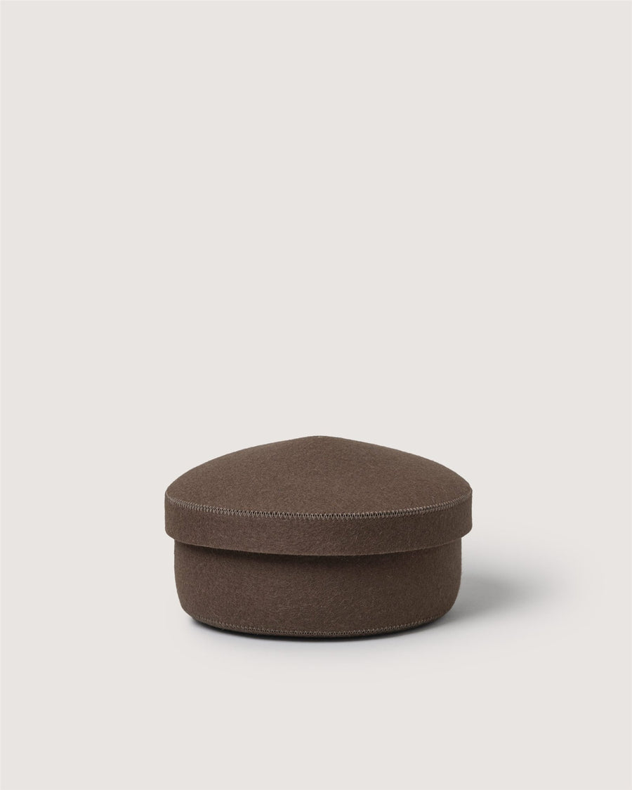 A brown, flat, round Graf Lantz box with a matching lid, set against a plain light background.