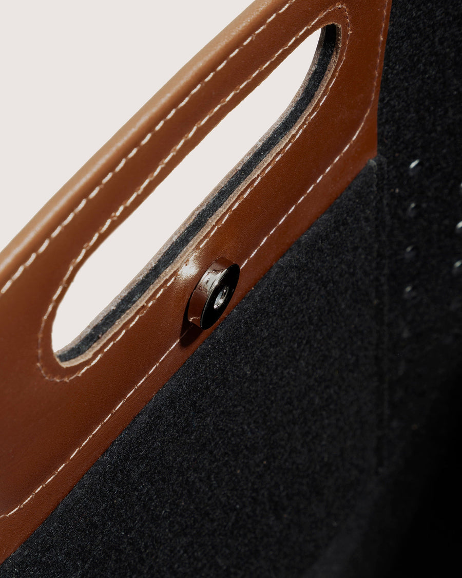 Interior of black Asobi Merino Wool Midi with brown leather applications and snap closure by Graf Lantz