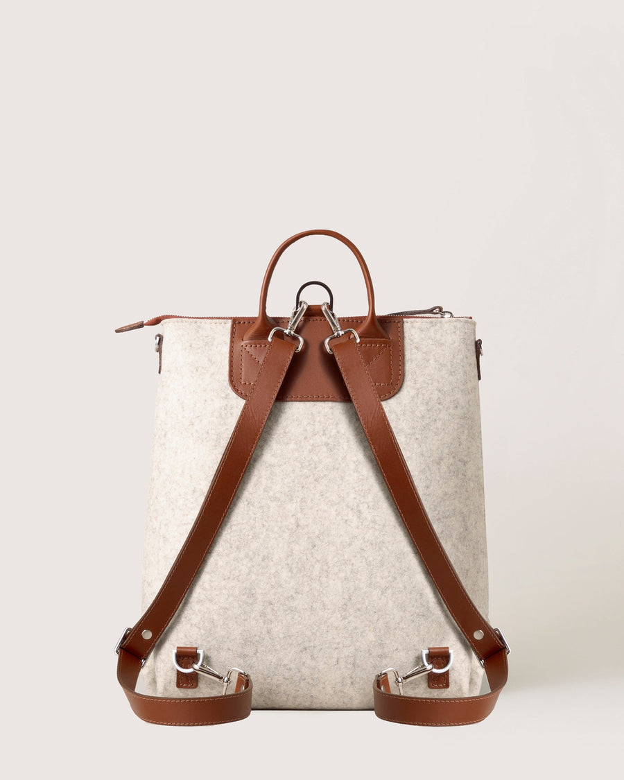 White Bedford Merino Wool Backpack with brown leather straps, rear view, white background