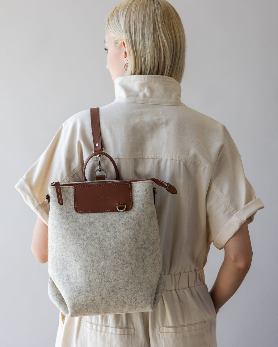 Woman with white Bedford Merino Wool Midi Back on her back, rear view, white background