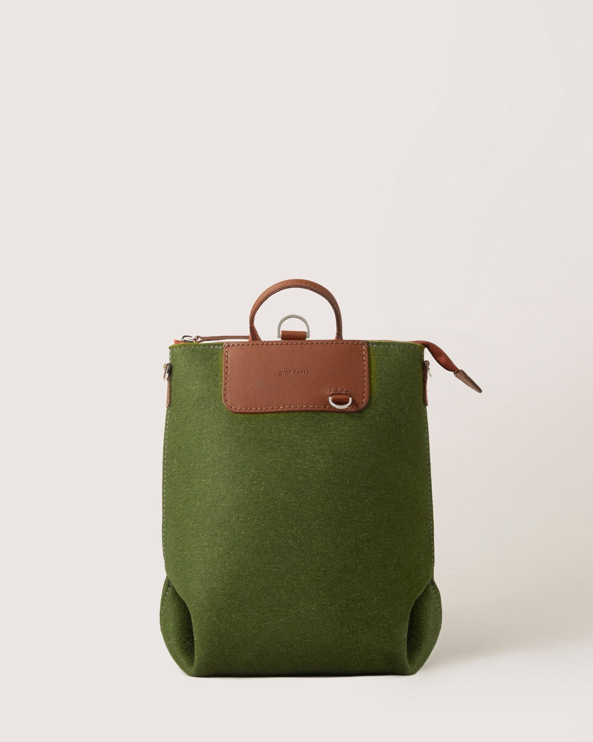 Bedford Merino Wool Midi Backpack in Moss with brown leather handles, front view, white background