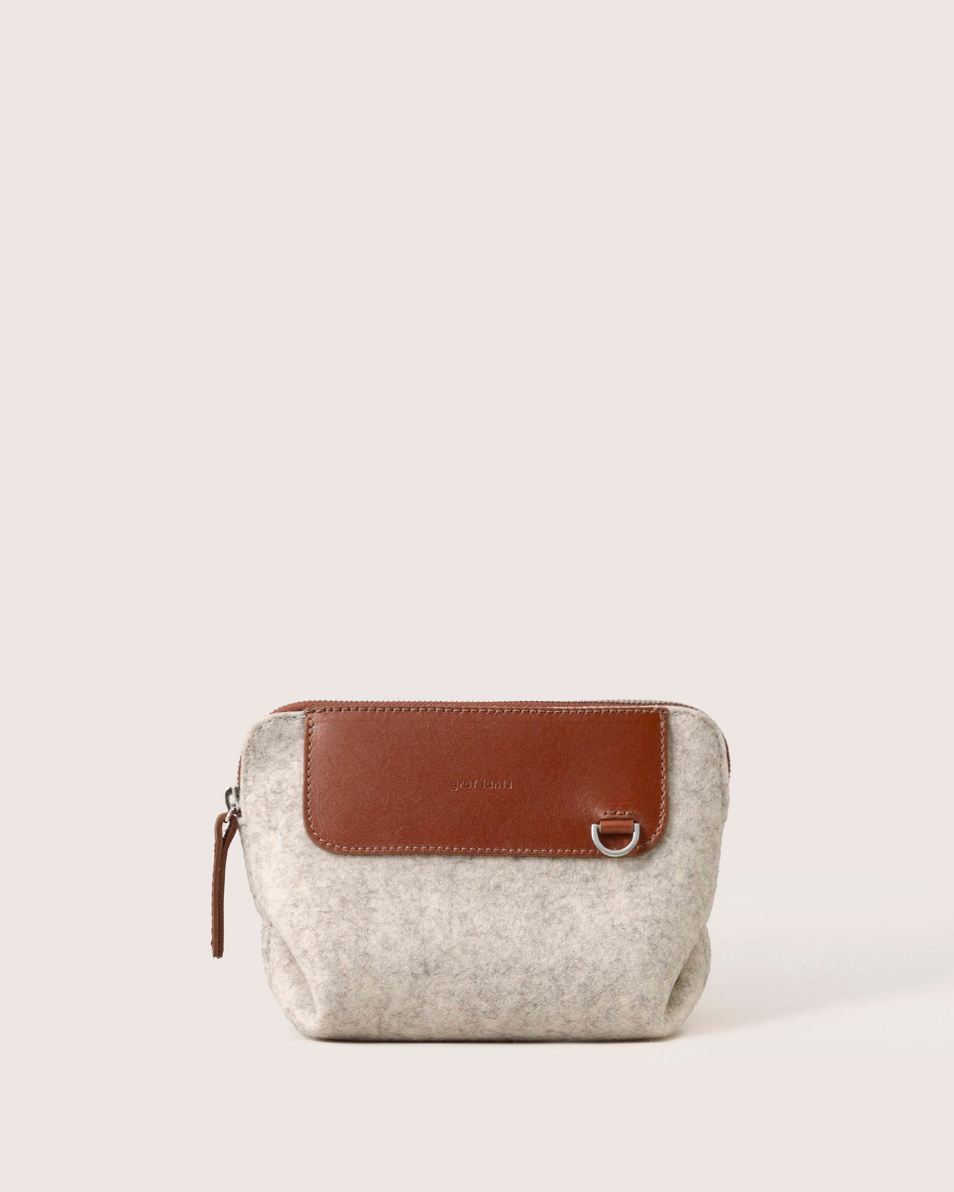 A stylish Bedford Merino Wool Belt Bag in heather white with brown leather accents, white background