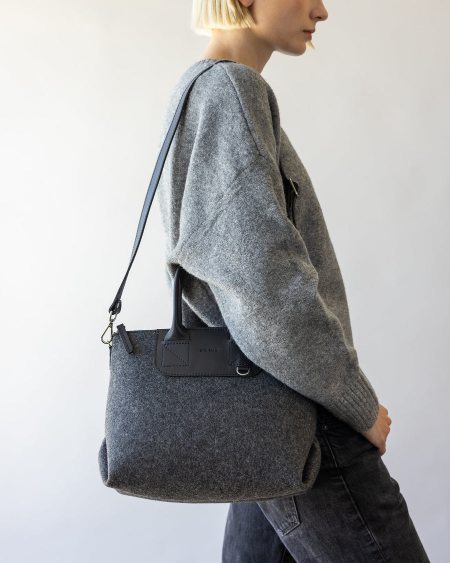 Standing woman with charcoal Bedford Merino Wool Stachel over her shoulder, side view