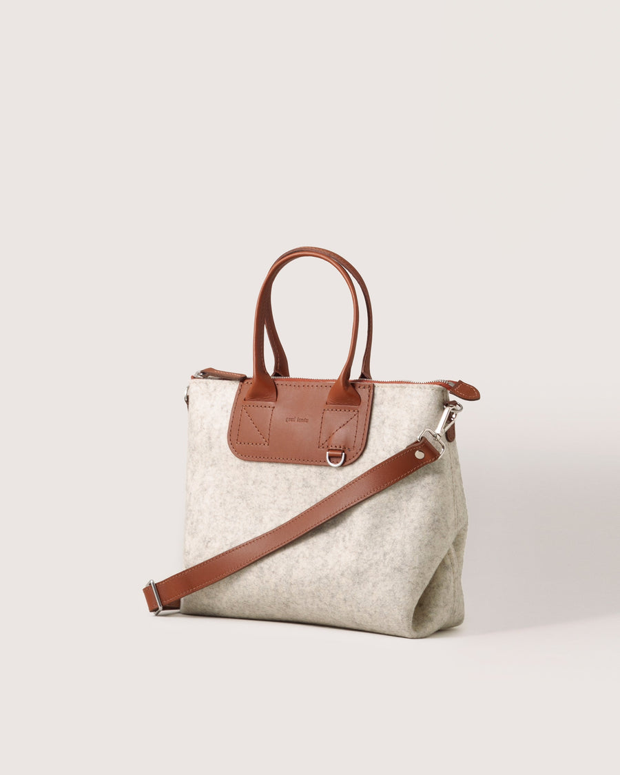 Bedford Merino Wool Satchel in Heather White with brown shoulder strap and leather handles, side view, white background