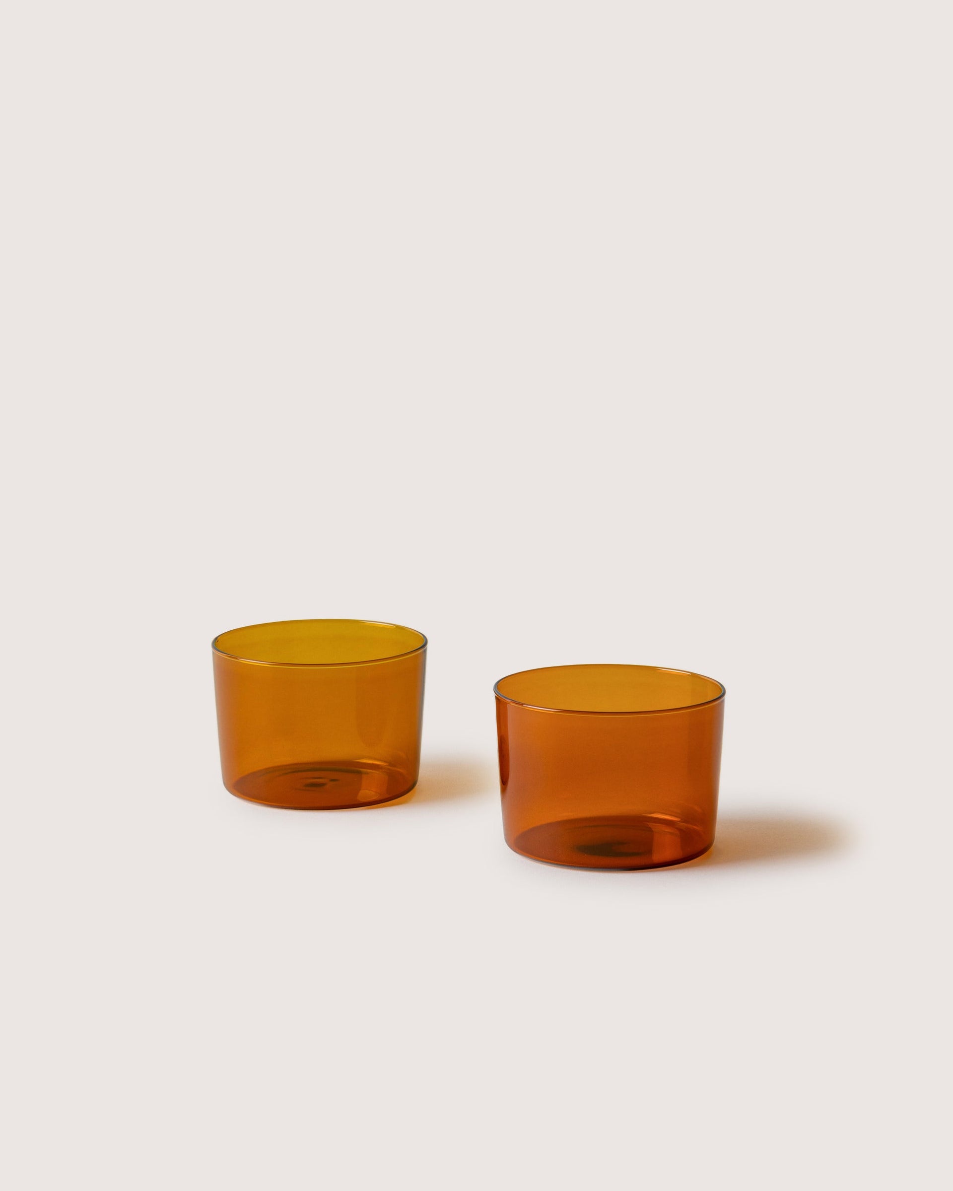 Two small Glas Half Tumbler in color Burnt Orange, white background