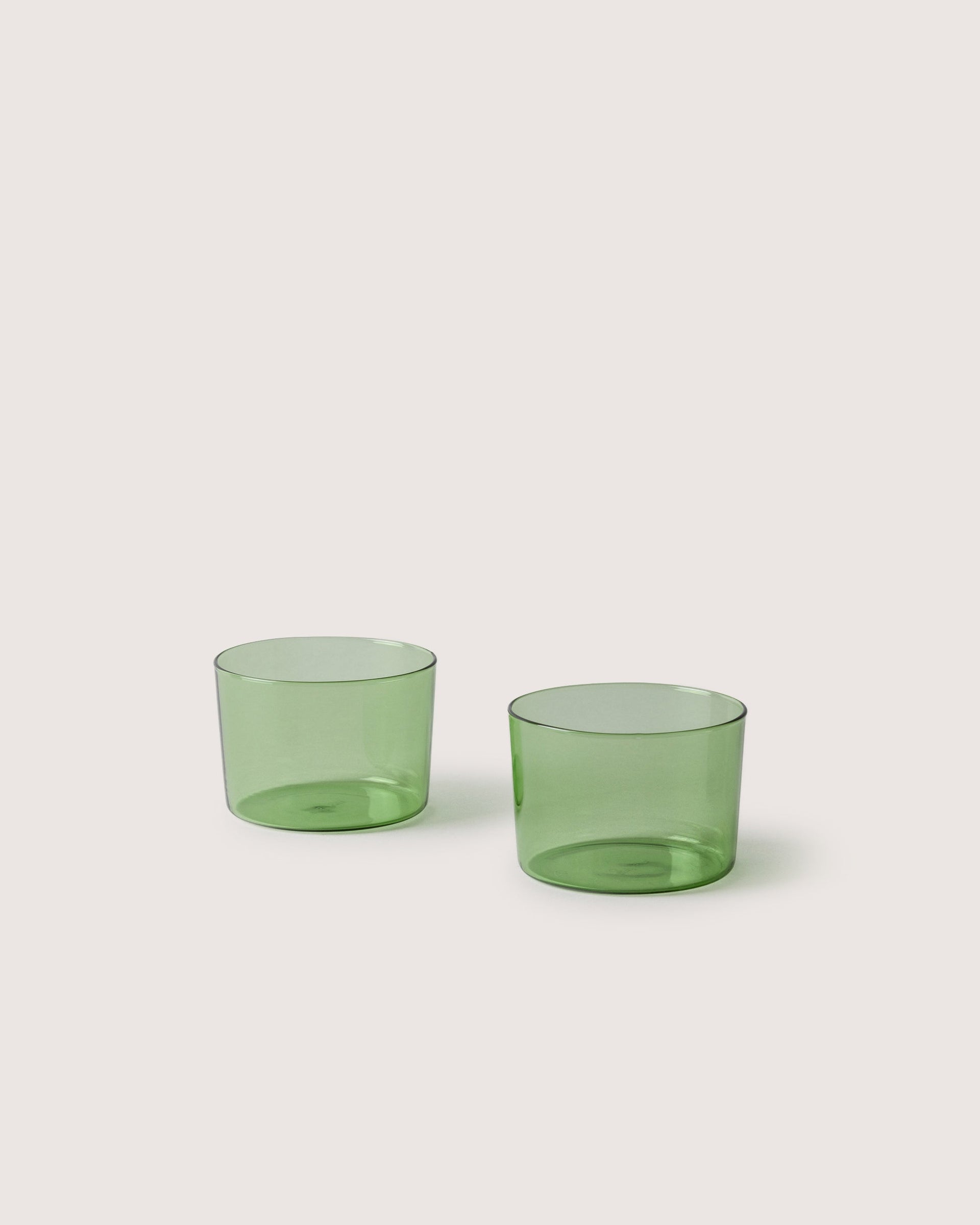 Two small Glas Half Tumbler in color cactus, white background