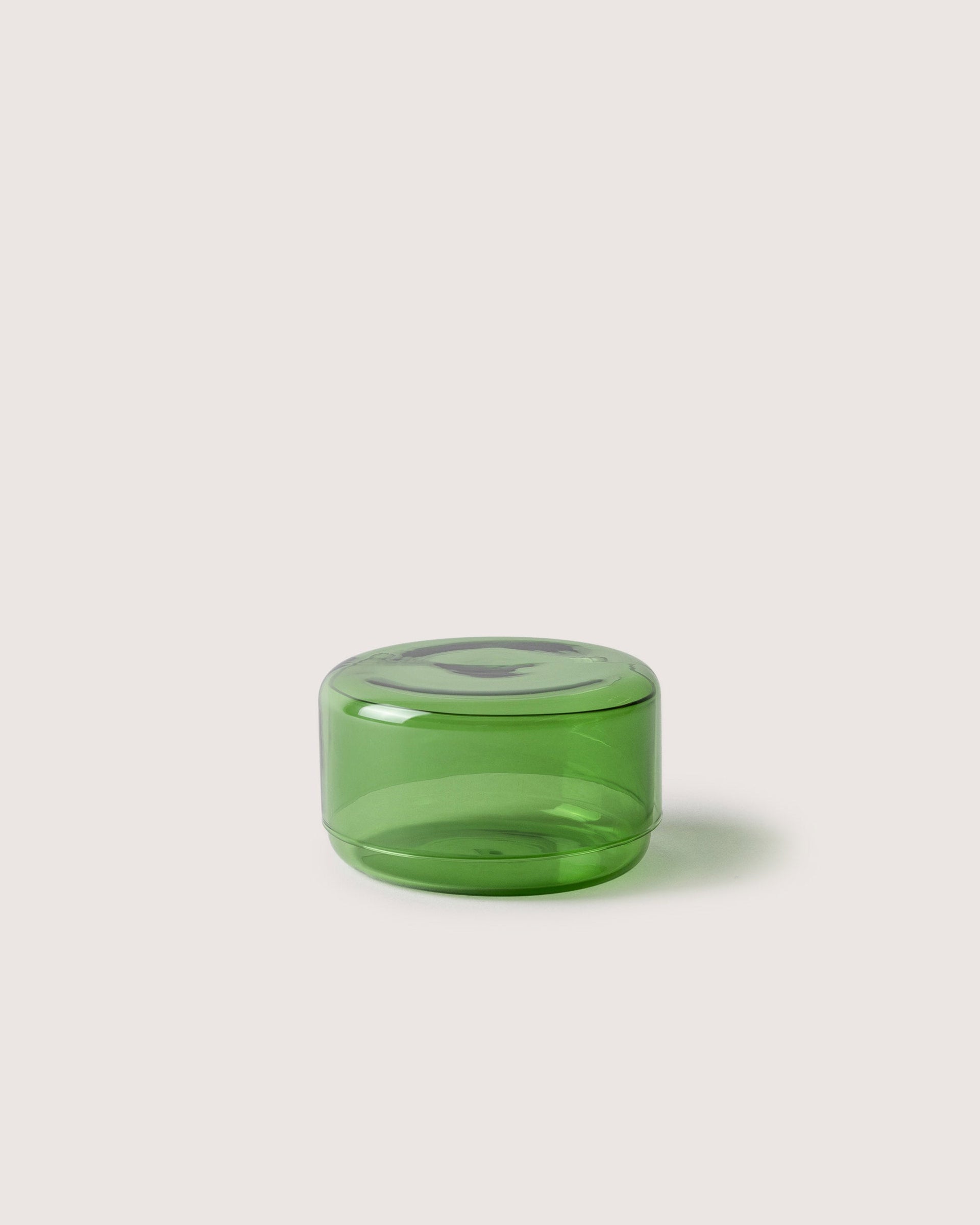 Small Lidded Container from Borosilicate glass in color cactus, white background