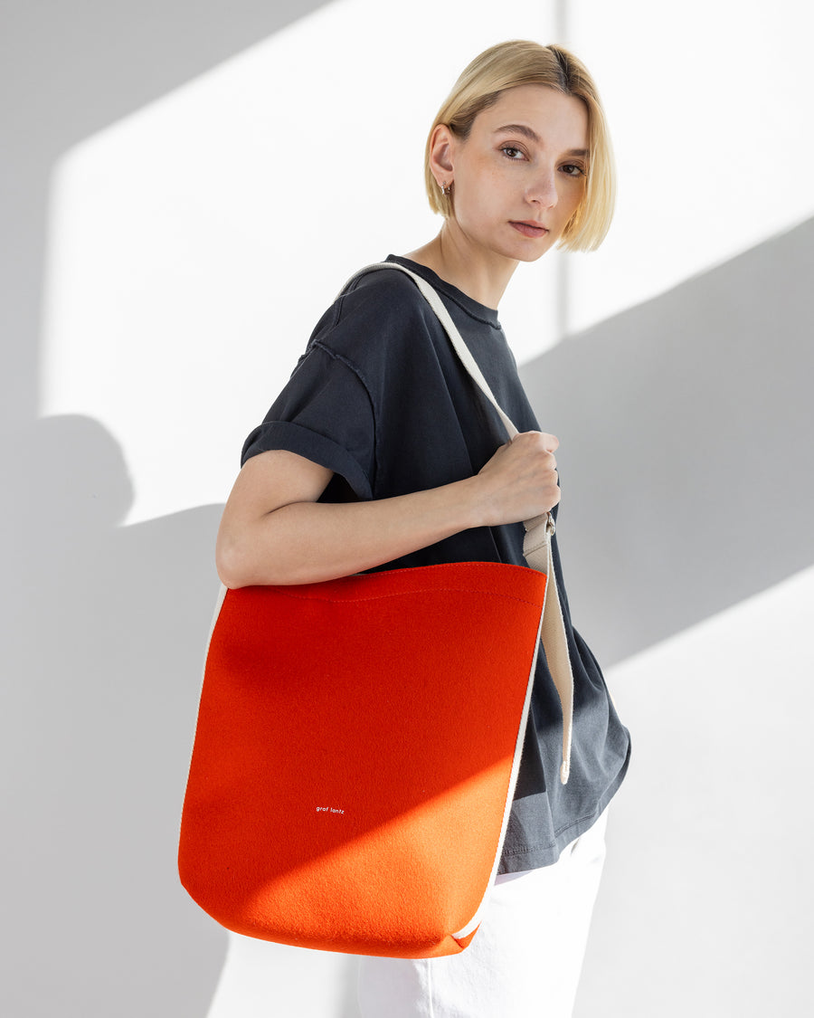 Dressier than a basic tote, but more casual than a handbag: our Campus Merino Wool Felt Tote, here in orange color