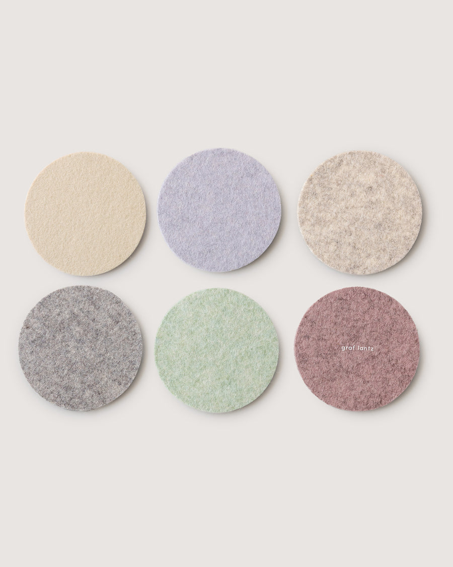 Six Merino wool felt coasters in round shapes and six dawn colors: heather white, granite, lamb's ear, feather, fog, rose quartz