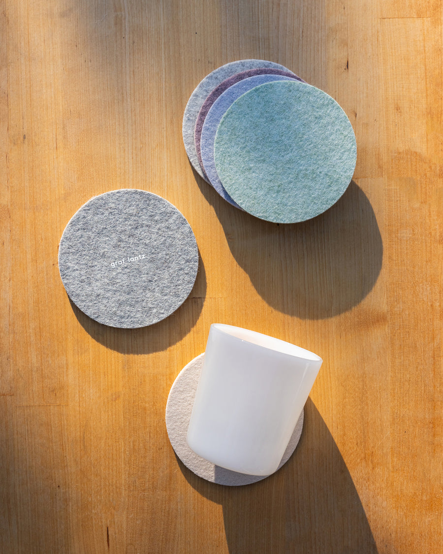 Four Merino wool felt coasters in round shapes and  two coasters below  
