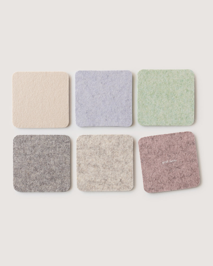 Six Merino wool felt coasters in square shapes and six dawn colors: heather white, granite, lamb's ear, feather, fog, rose quartz