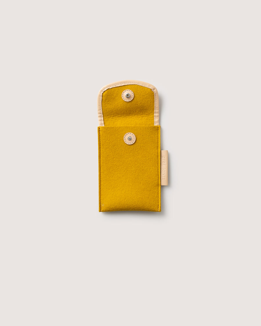 Protect your phone or other small items with our Envelope Accessory Sleeve. Here in dijon color.