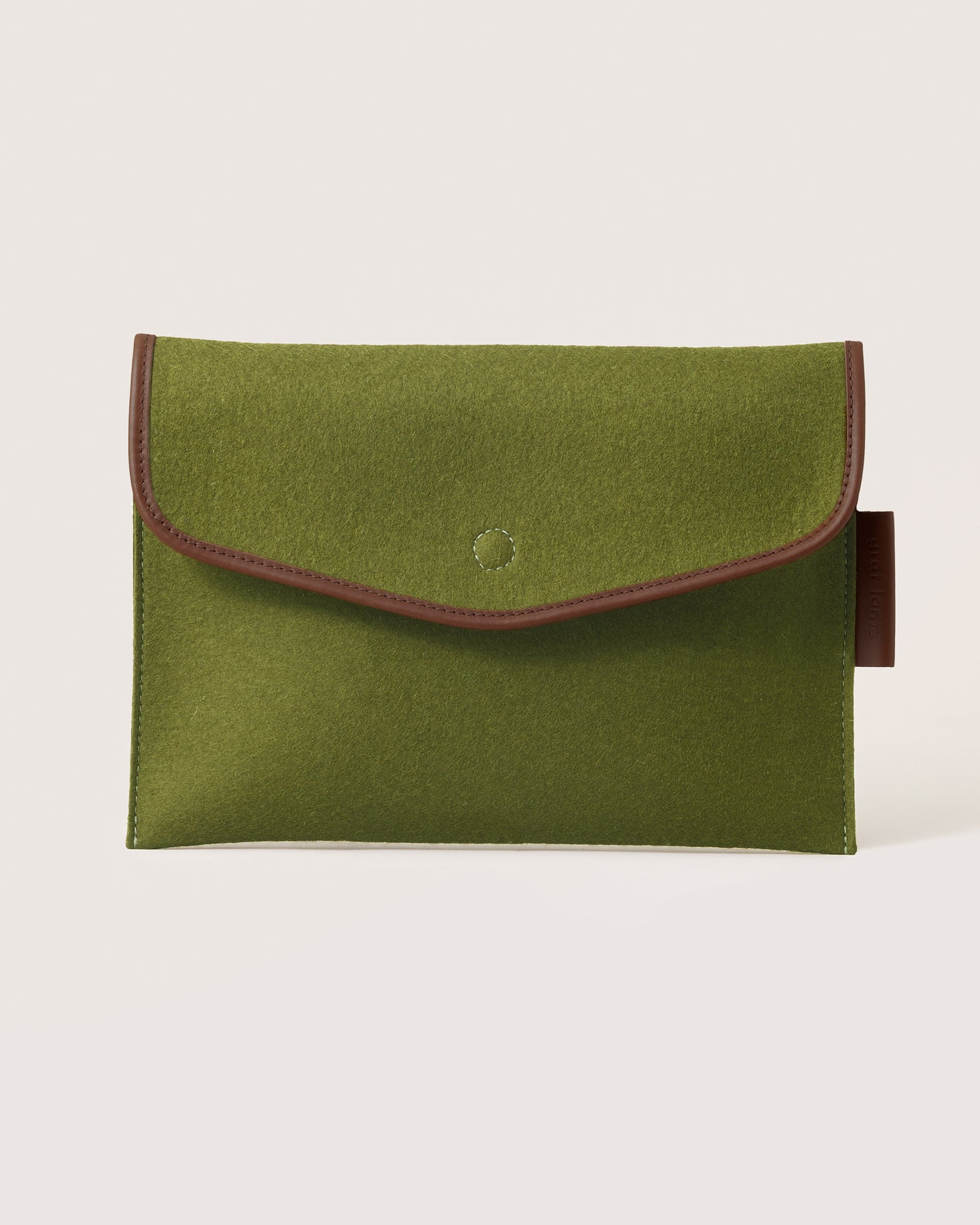 Envelope Merino Wool 16" Tech Sleeve in moss color with dark brown leather application by Graf Lantz, front view
