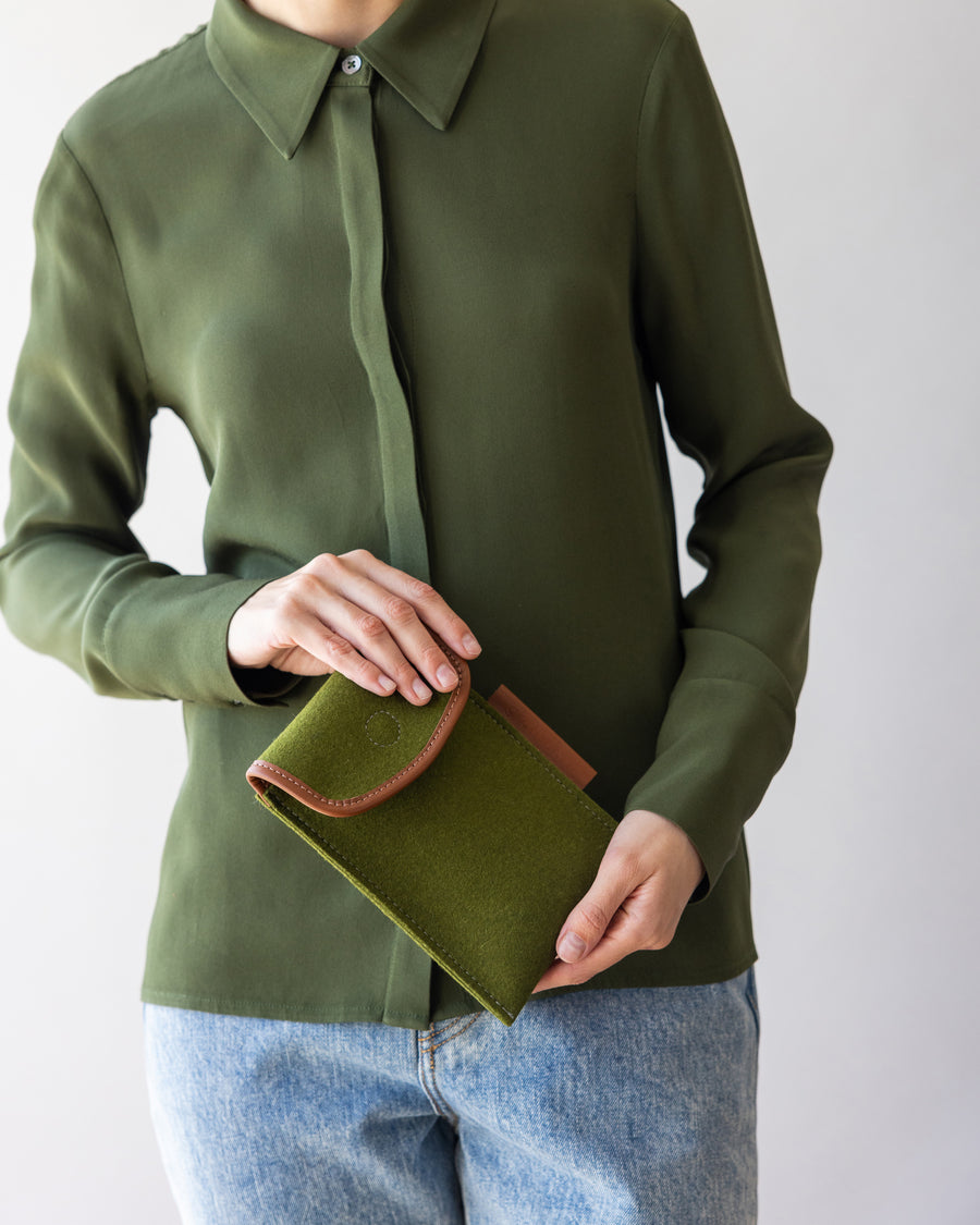 Merino Wool Envelope Accessory Sleeve in  green held by a woman in both hands, front view