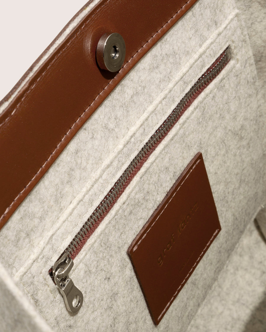 Inside view of Frankie Midi in heather white and brown leather handle application