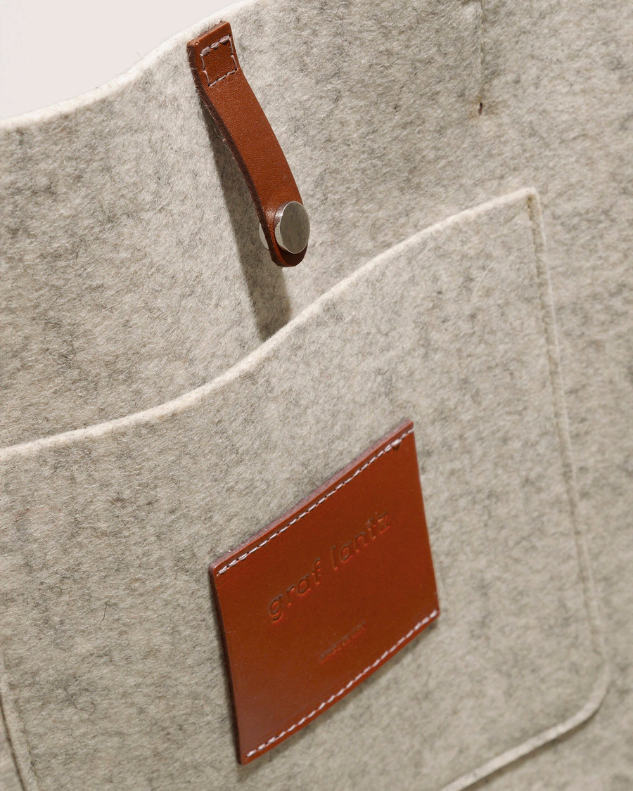 View inside a Heather white Hana Merino Wool Tote bag by Graf Lantz featuring pocket, snap closure, and brown leather applications.