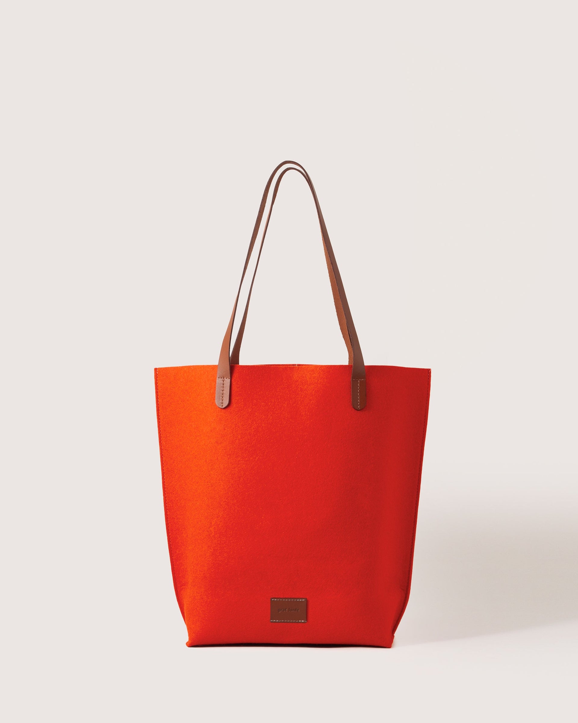 Orange Merino Wool Tote bag with brown leather handle, front view, white background