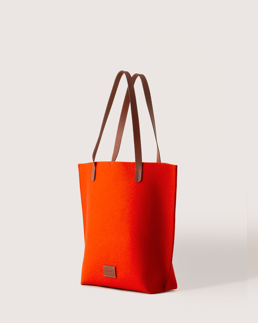 Orange Merino Wool Tote bag with brown leather handle, side view, white background