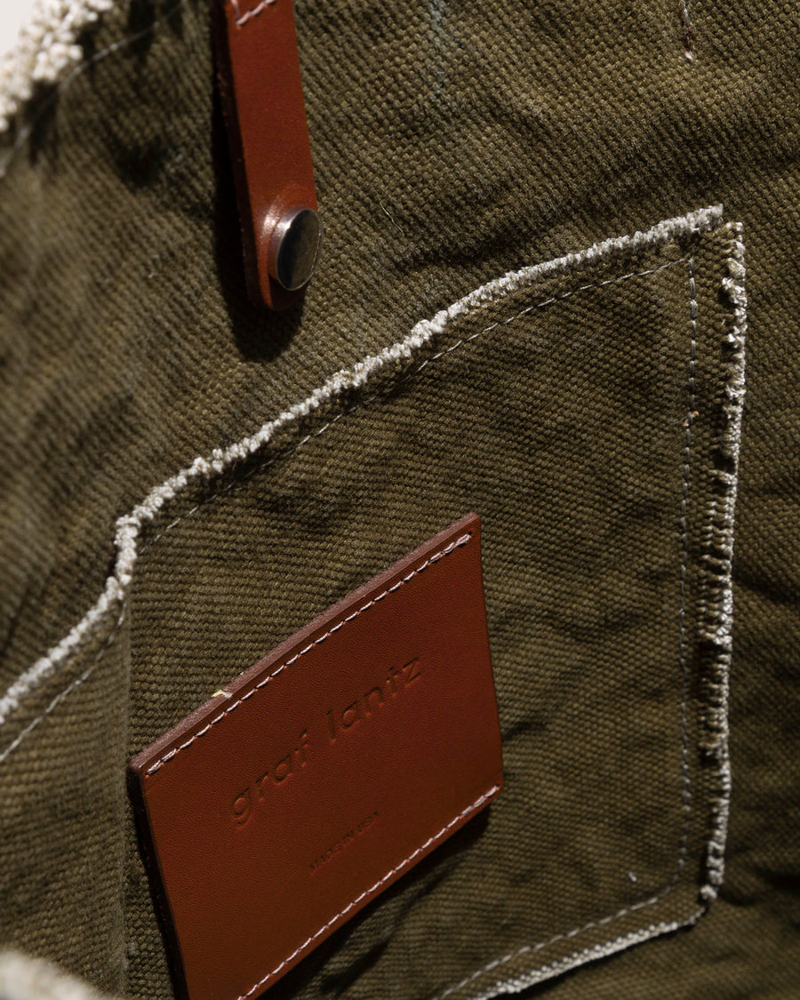 Interior pocket of a green Hana Canvas Boat Bag by Graf Lantz with dark brown leather applications