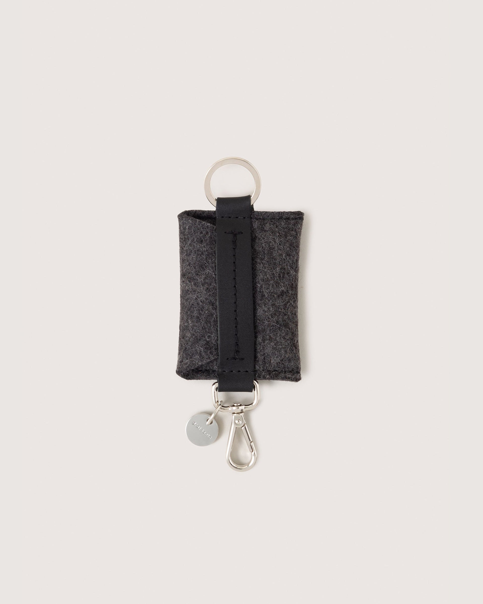 Charcoal Merino Wool Card Key Fob with silver colored Lobster Clasp, Flat Wide Keyring, and Logo Tog Tag, white background.