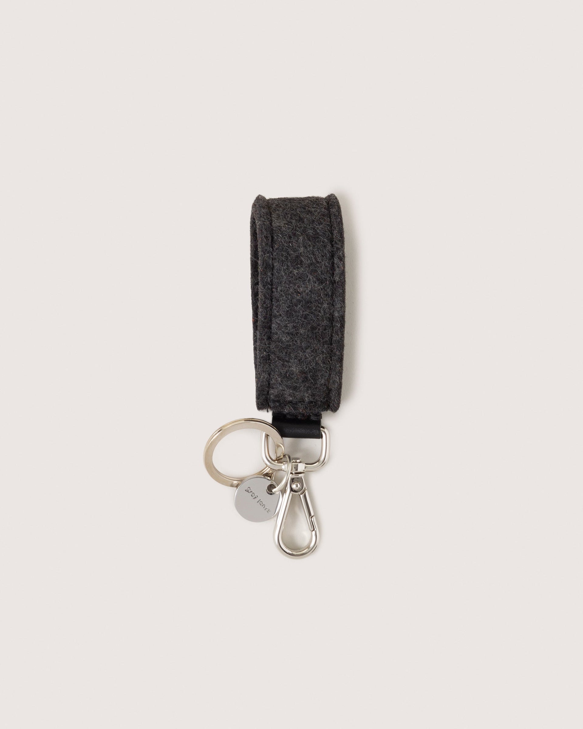 Charcoal Merino Wool Loop Key Fob with silver colored Lobster Clasp, Flat Wide. Keyring, and Logo Tog Tag, white background