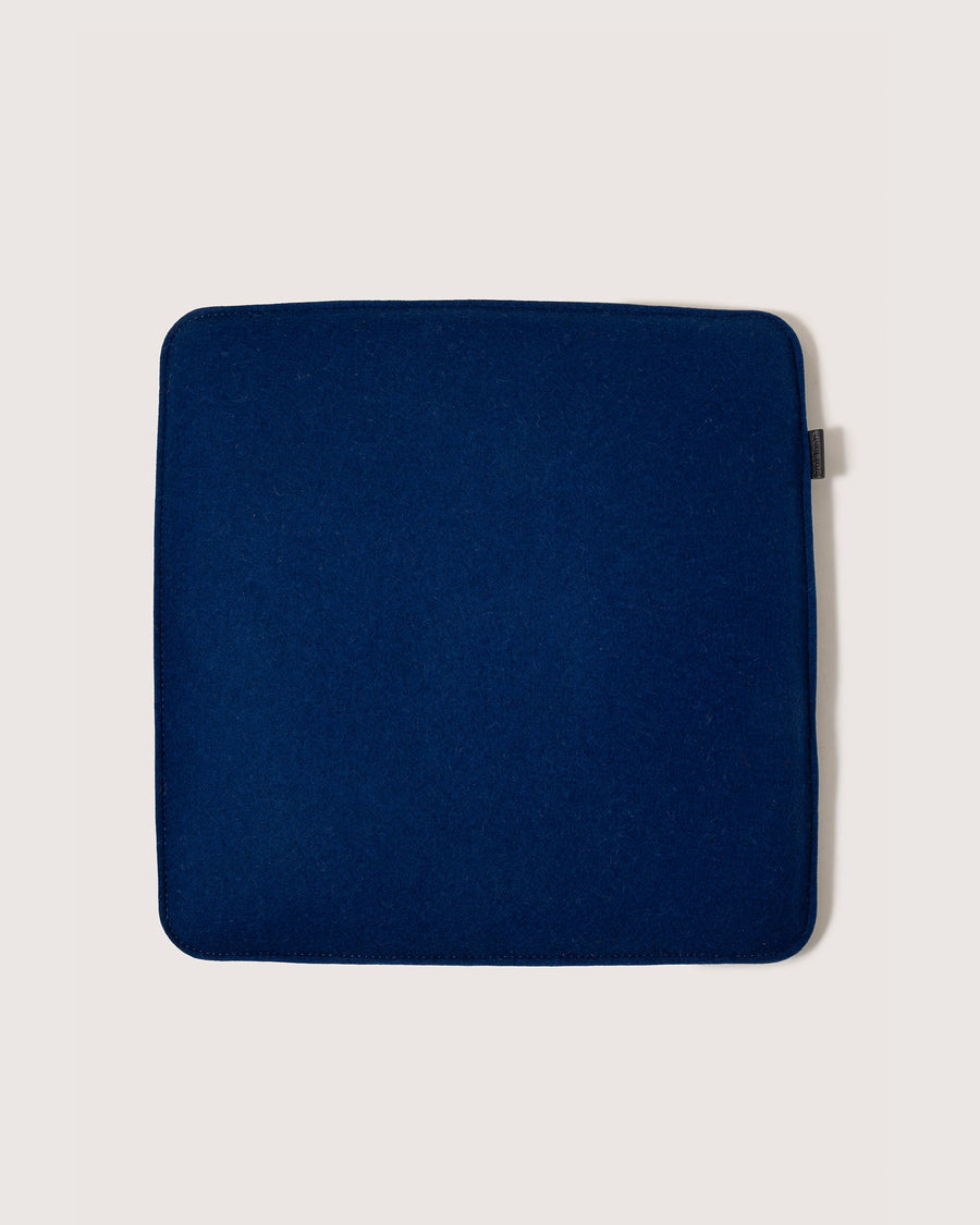 A Zabuton Merino Wool Square Seat Pad by Graf Lantz in Marine color, white background